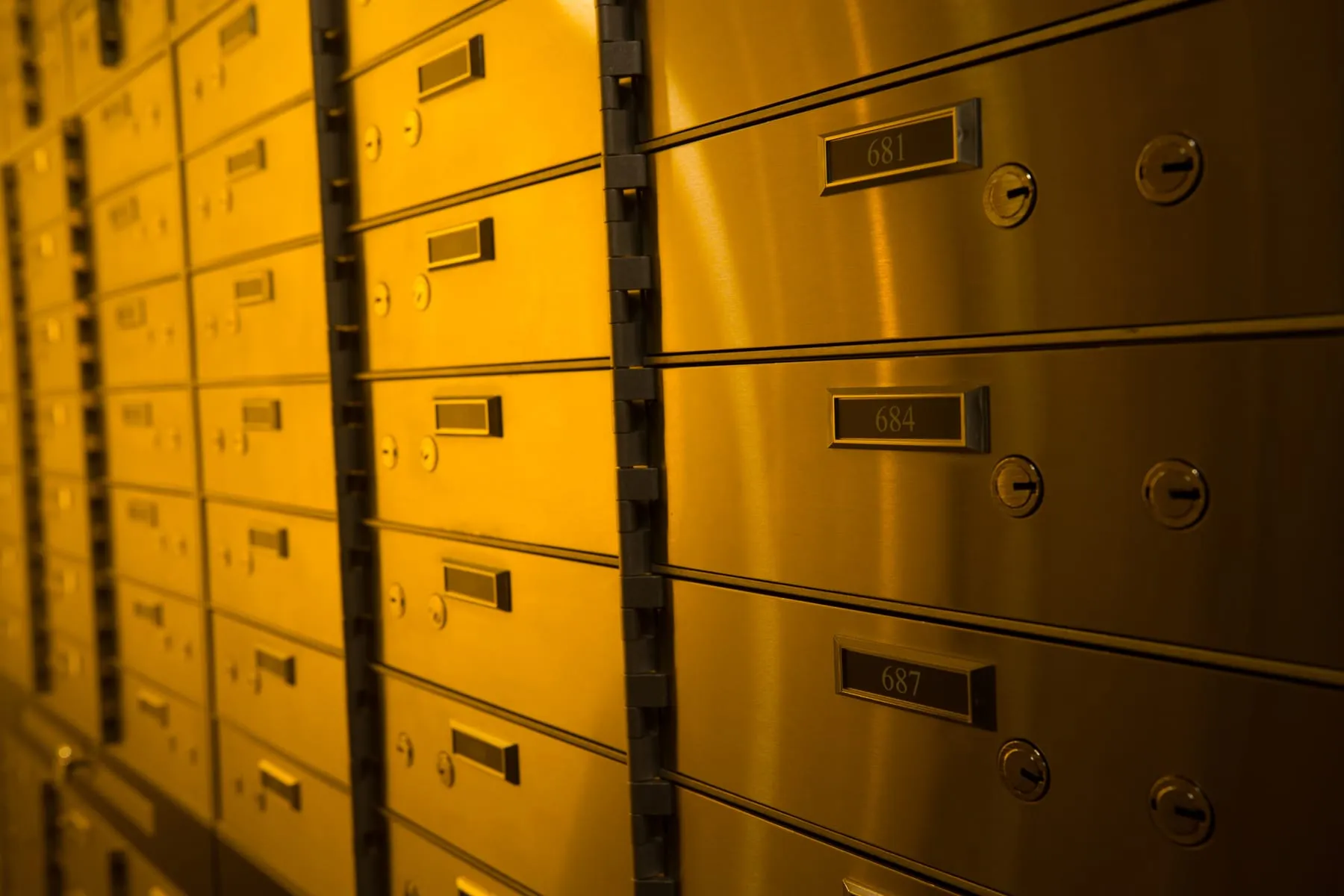 Gold-lit private safety deposit boxes at Fortis Vaults