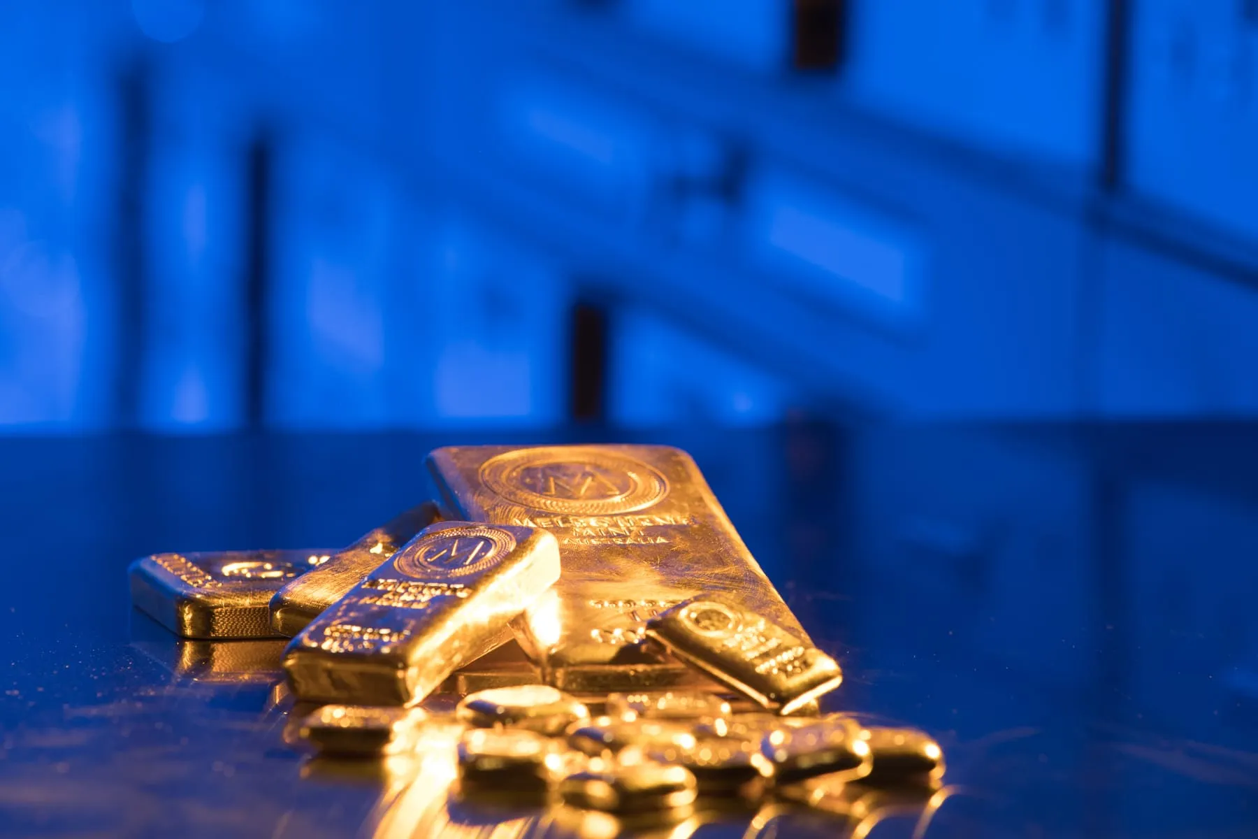 Gold bullion bars and coins in private vault storage